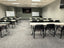 workplace training room with tables in line and two whiteboards